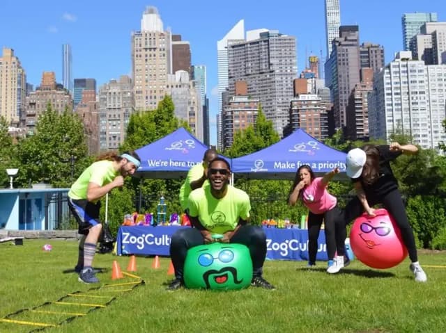 people racing on bouncing balls in a field day event